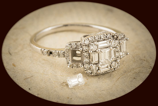 An engagement ring with an accent diamond missing