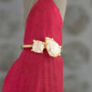 Two stone ring with pear and cushion cut lab diamond on yellow gold setting on red cloth