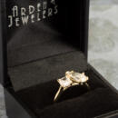 Two stone ring with pear and cushion cut lab diamond on yellow gold setting in Arden Jewelers ring box