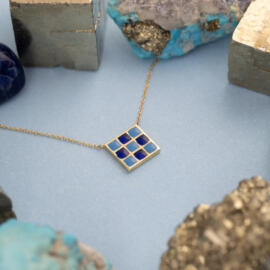 Blue Checkered Enamel Necklace in 14 karat Yellow Gold with cable chain posed side.