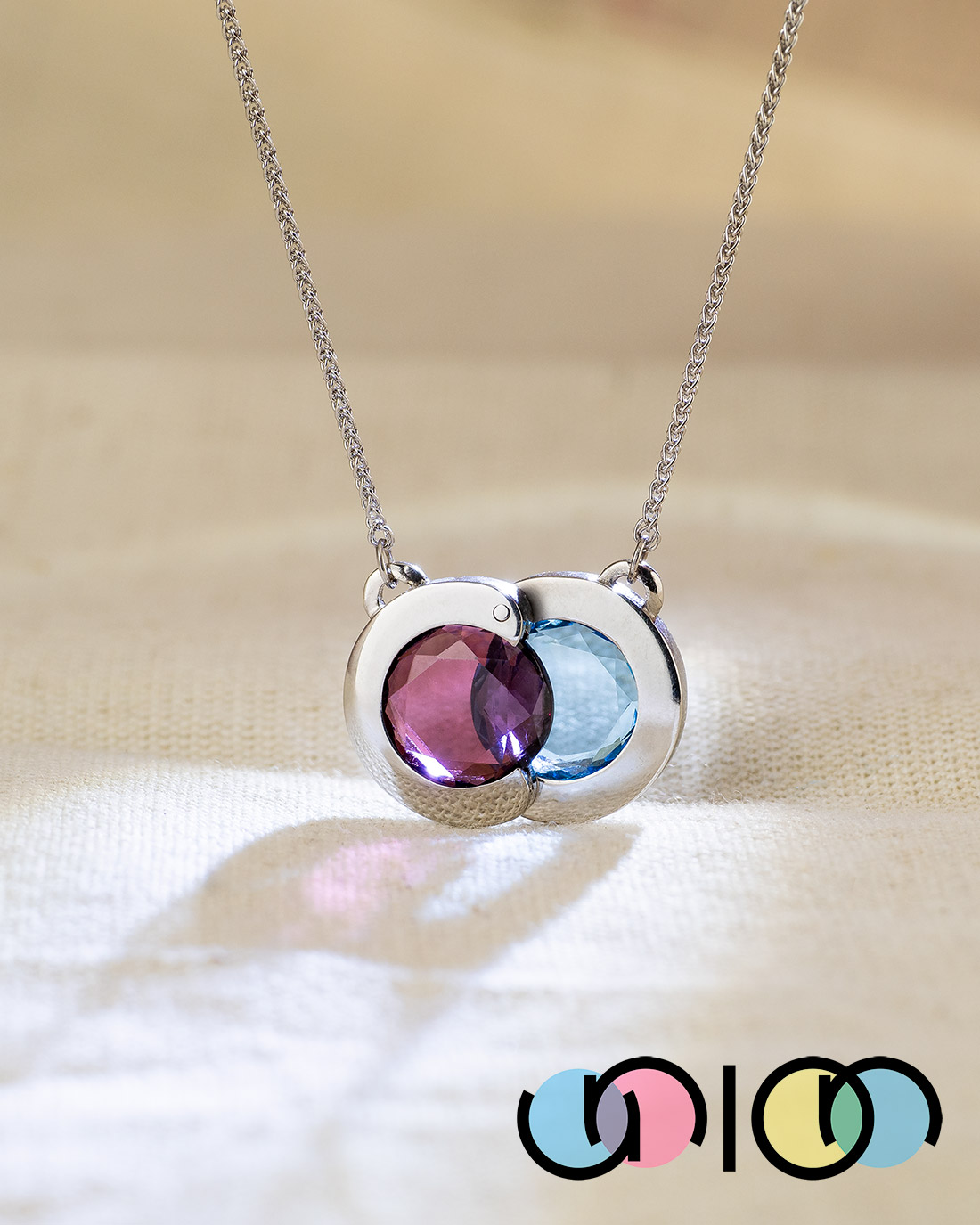 Union pendant with rhodolite garnet and blue topaz in white gold